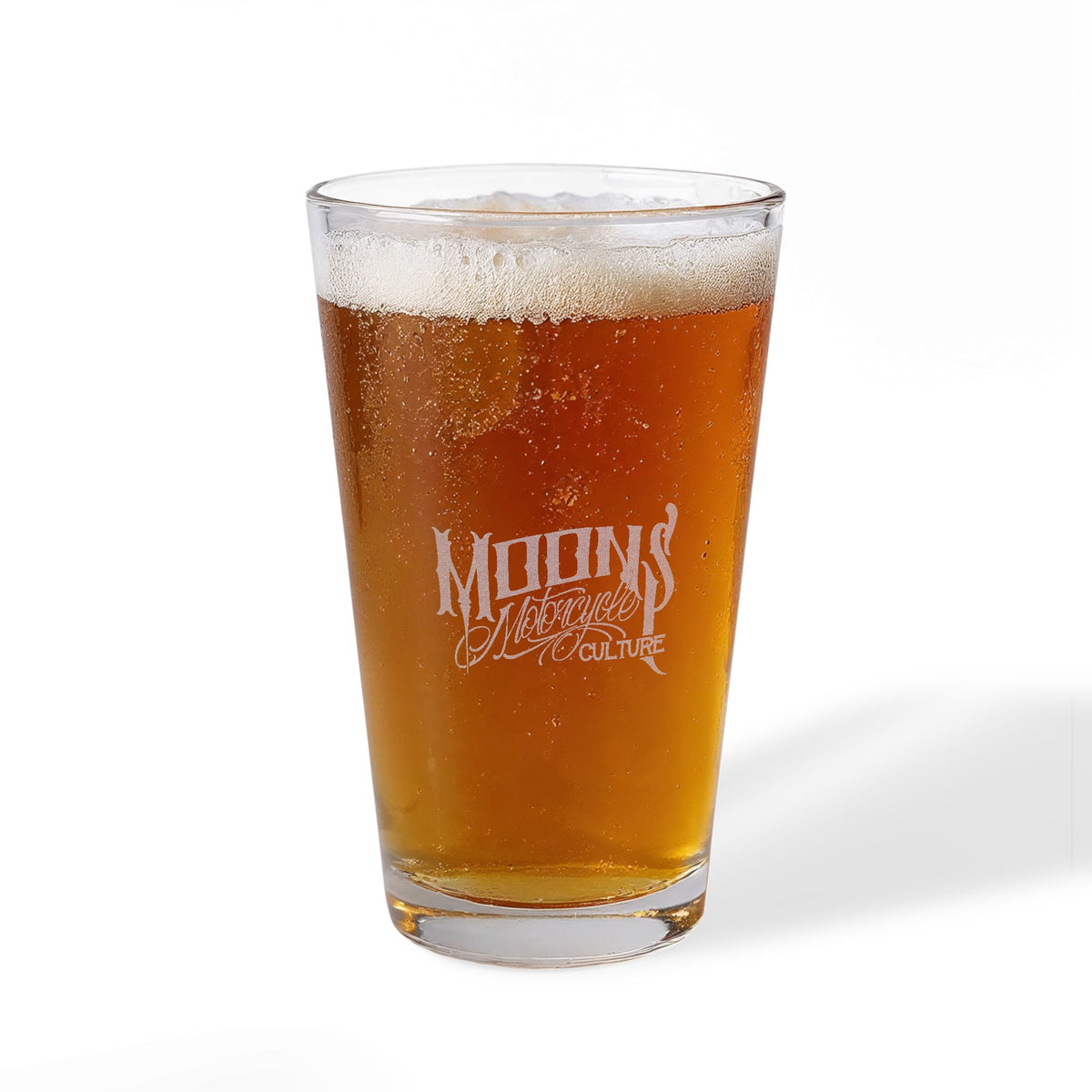 Opposite side of the beer-filled MOONSMC The Saloon pint glass showing the smaller engraved lettering.