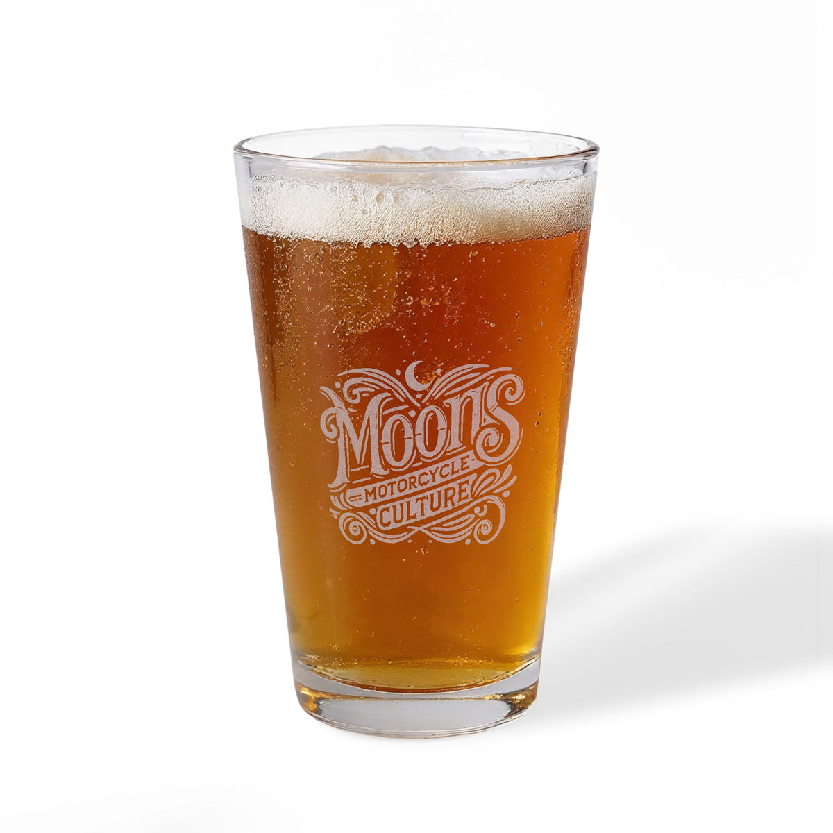 MOONSMC The Saloon pint glass filled with beer, showing the large engraved logo.