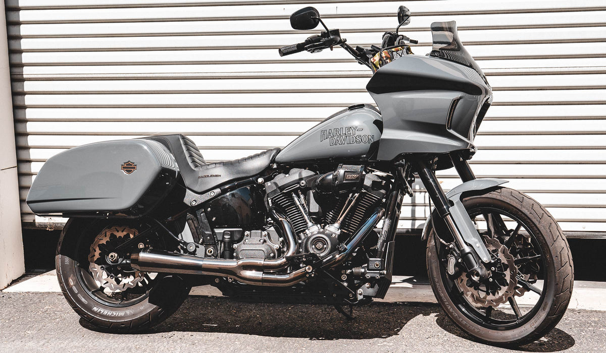 Gray Harley-Davidson Low Rider ST with MOONSMC parts outside a workshop