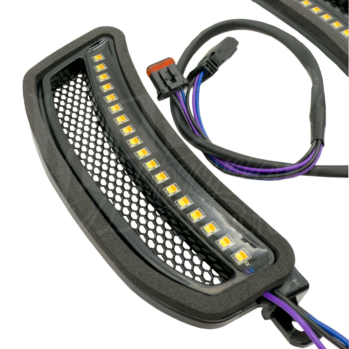 Angled close-up of an FXLRST mesh vent insert showing its LED strip and wiring connector.