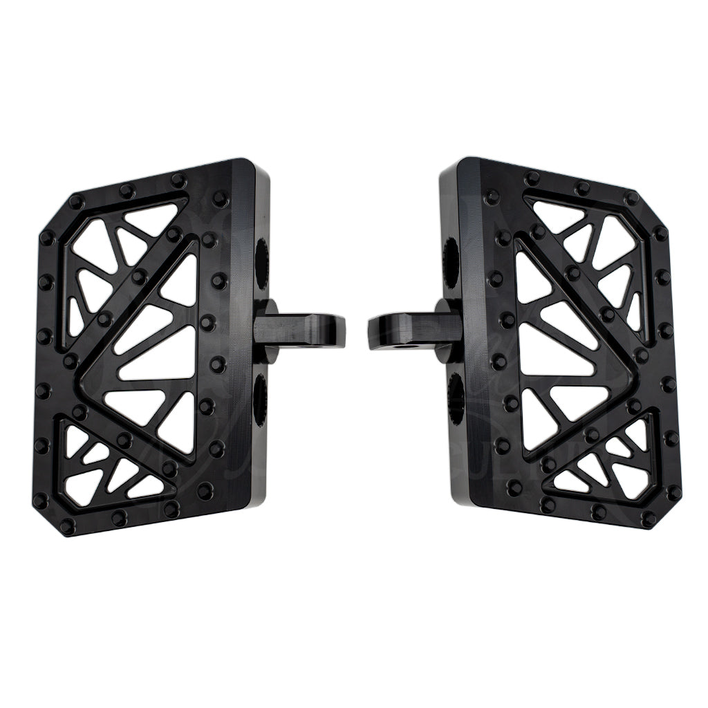 Pair of black MOONSMC mini floorboards for Dyna, FXR and Sportster, showing geometric cutouts and traction pins.