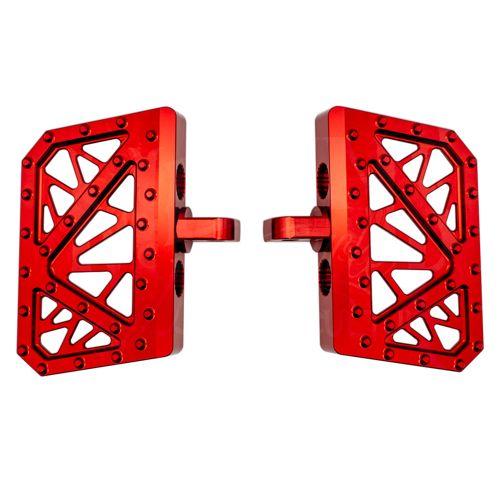 Pair of red MOONSMC mini floorboards for Dyna, FXR and Sportster, showing geometric cutouts and traction pins.