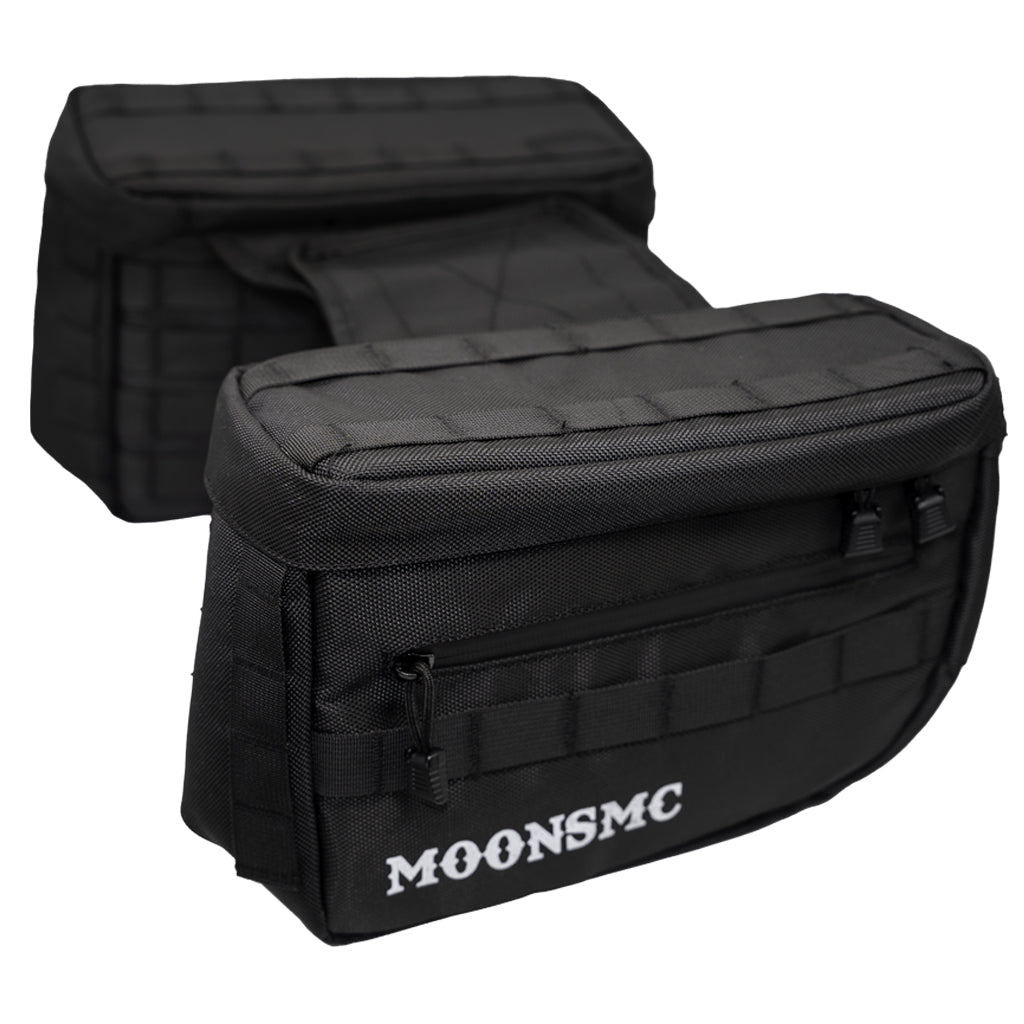 Pair of black MOONSMC RECON saddlebags showing their front pockets and top lids.