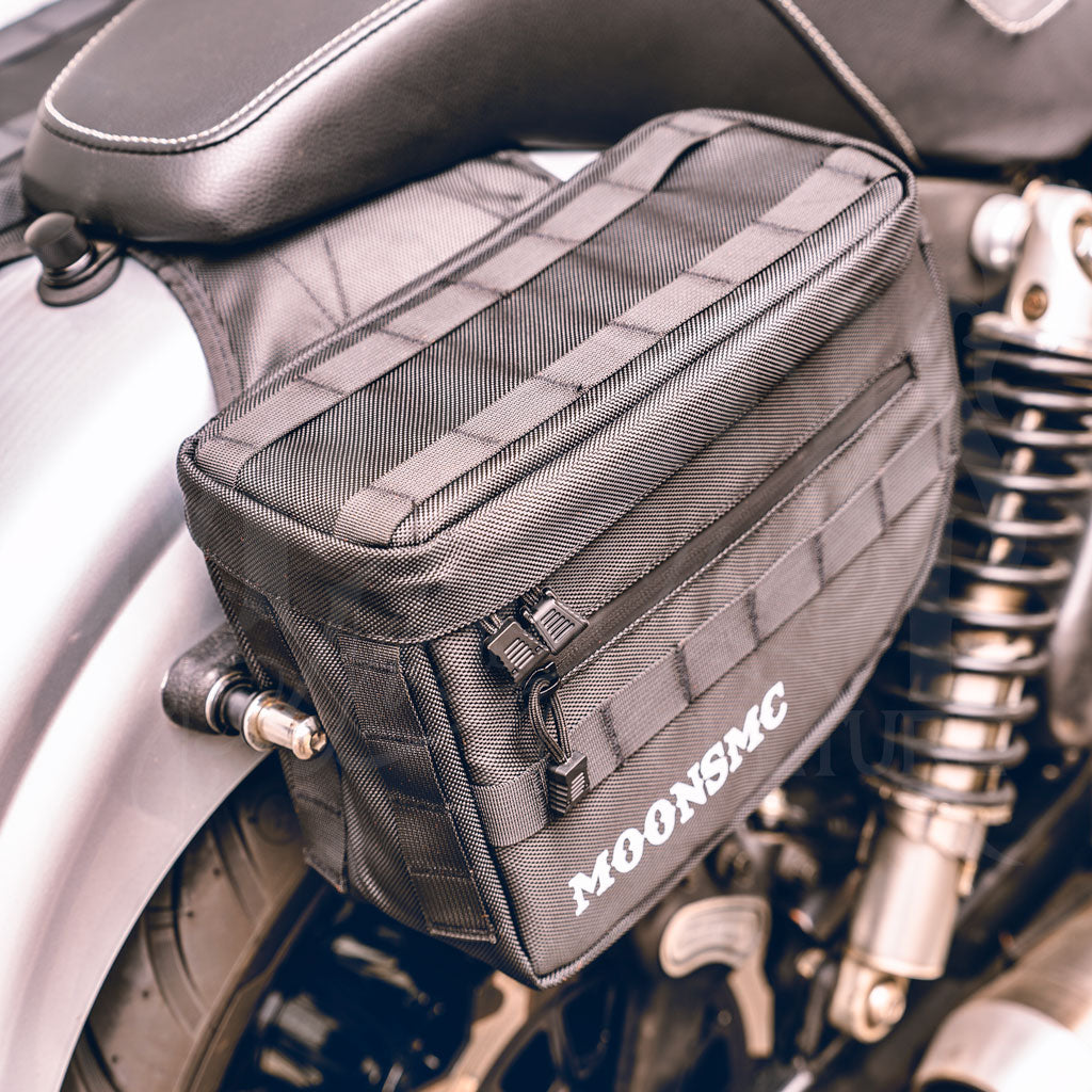 Top and front view of an installed MOONSMC RECON saddlebag showing webbing on the lid.
