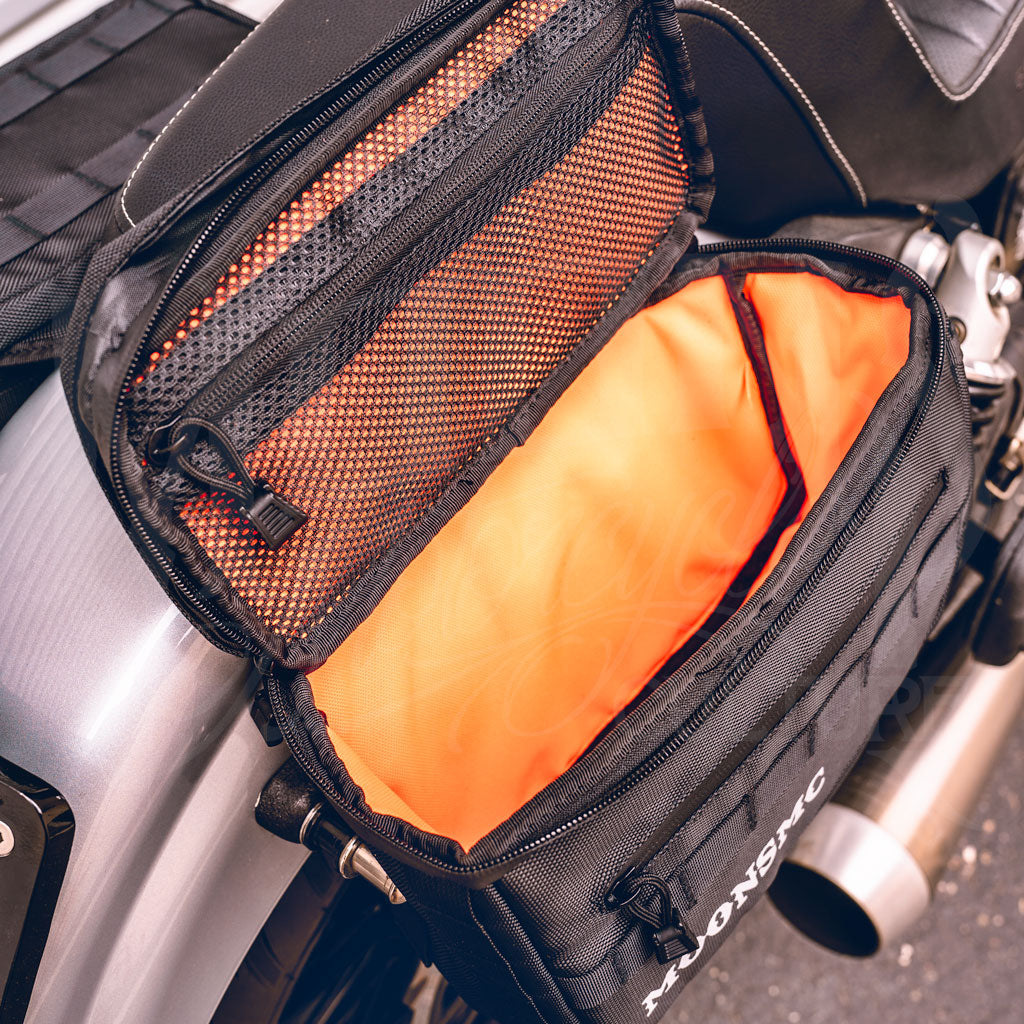 Top view into an open MOONSMC RECON saddlebag showing its orange interior.