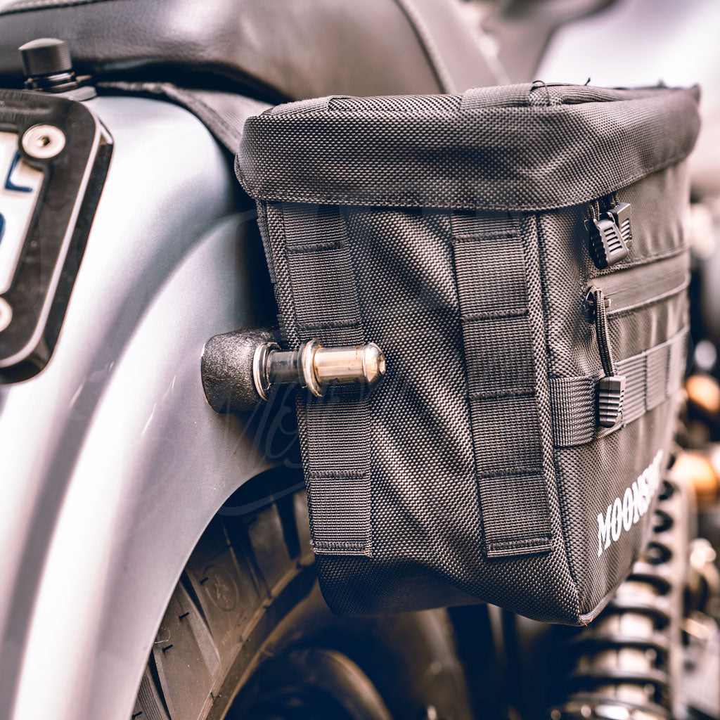 End view of an installed MOONSMC RECON saddlebag showing side webbing and straps.