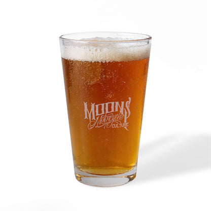 Opposite side of the beer-filled MOONSMC The Saloon pint glass showing the smaller engraved lettering.