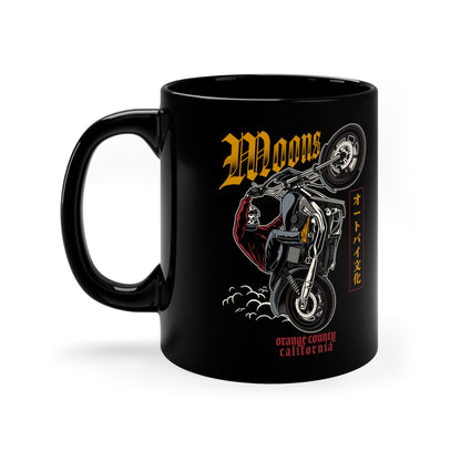 MOONSMC Dyna Wheelie 11oz Black Mug: black mug showing the motorcycle wheelie graphic, handle on the left.