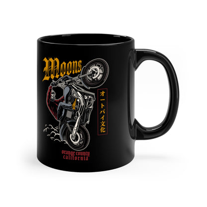 MOONSMC Dyna Wheelie 11oz Black Mug: black mug showing the motorcycle wheelie graphic, handle on the right.