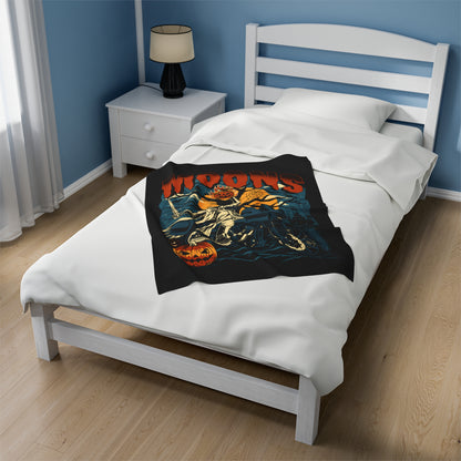 MOONSMC 2024 Halloween Edition - FXLRST Headless Horsemen Graveyard Indigo Velveteen Plush Blanket: smaller printed blanket displayed at the center of a bed.