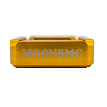 MOONSMC "The Diplomat" Cigar Ashtray: side view of the gold tray with MOONSMC lettering.
