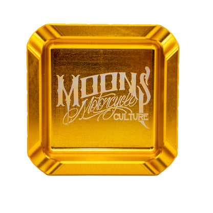MOONSMC "The Diplomat" Cigar Ashtray: top view in gold showing the engraved logo.