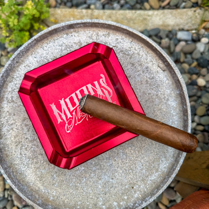 MOONSMC "The Diplomat" Cigar Ashtray: top view of a red tray holding a cigar.