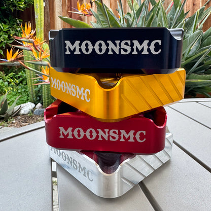 MOONSMC "The Diplomat" Cigar Ashtray: black, gold, red and silver trays stacked outdoors.