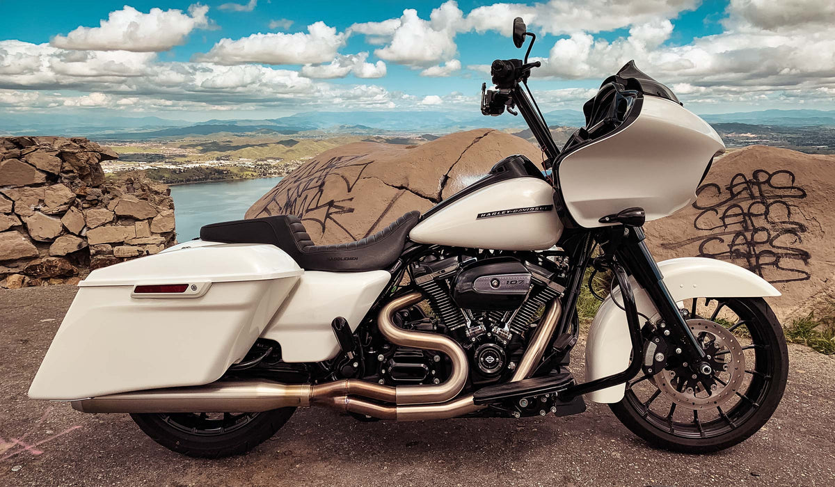 White Harley-Davidson touring motorcycle overlooking a lake and rocky hills