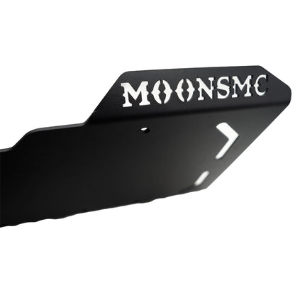 Close-up of the MOONSMC lettering cut into the side of the Softail M8 full lower skid plate.