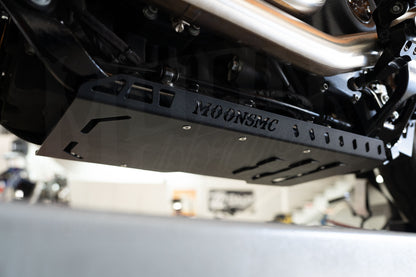 Angled underside view of the MOONSMC Softail M8 full lower skid plate and its vent slots.