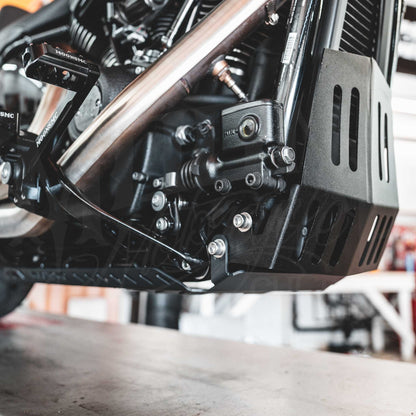 Front view beneath a Softail M8 engine showing the installed MOONSMC full lower skid plate.