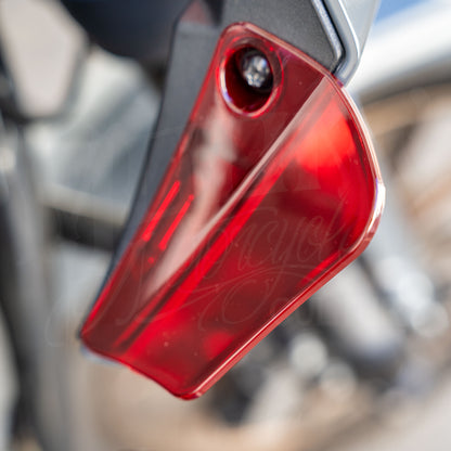Close-up of a red MOONSMC air deflector installed on a Softail FXLRST fairing.