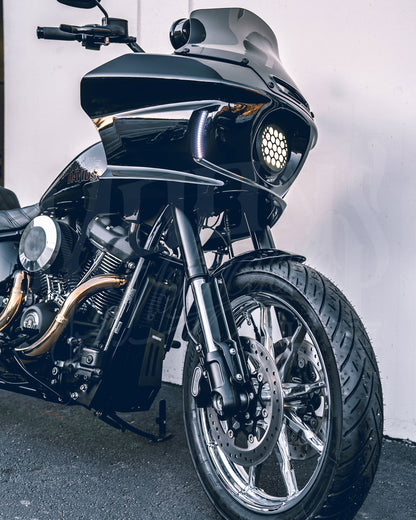 Front three-quarter view of a black motorcycle with an FXLRST-style fairing and round LED headlight.