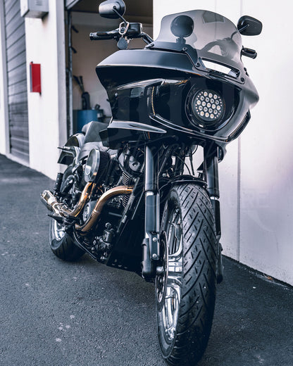 Front view of a motorcycle fitted with a black MOONSMC FXLRST-style fairing and round headlight.