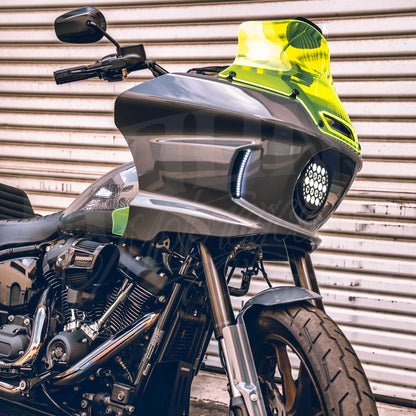 Lime green MOONSMC 8.5-inch recurve windshield installed on a gray Softail FXLRST fairing.