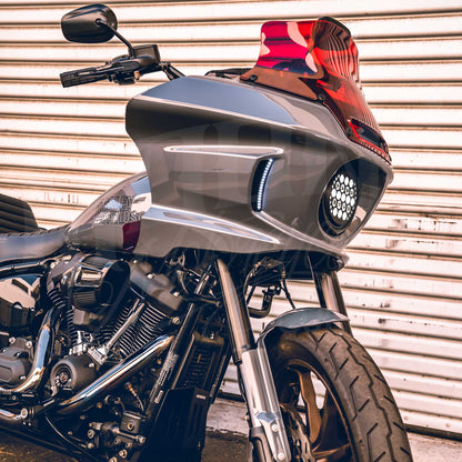 Red MOONSMC 8.5-inch recurve windshield installed on a gray Softail FXLRST fairing.