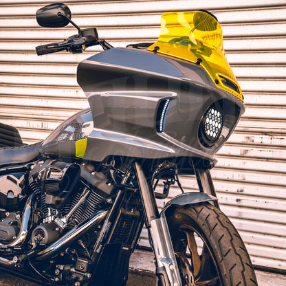 Yellow MOONSMC 8.5-inch recurve windshield installed on a gray Softail FXLRST fairing.