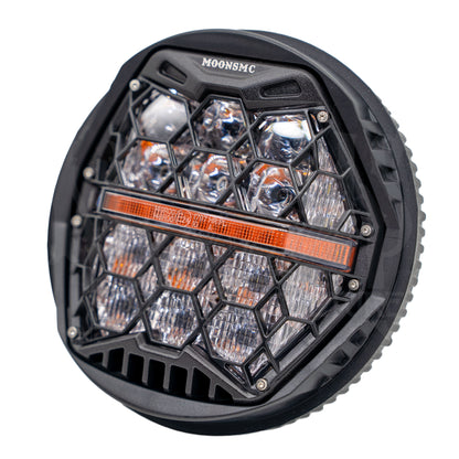 Angled view of the MOONSMC 5.75-inch HexBeam Pro headlight with clear lenses and a black housing.