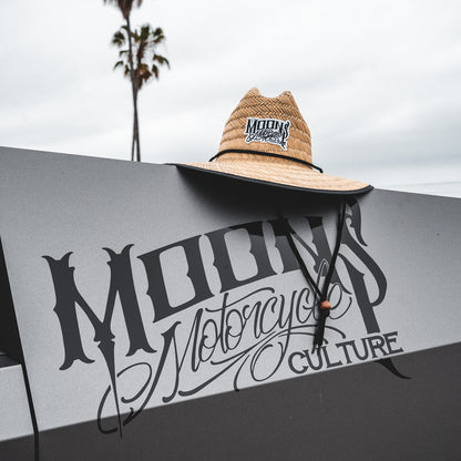 MOONSMC OG Logo UPF 50+ Lifeguard Straw Hat: straw hat displayed above a MOONSMC sign.
