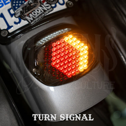 MOONSMC V4 tail light displaying red running lights and an amber turn-signal segment.