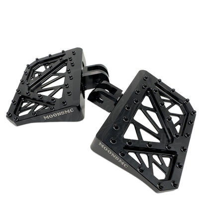 Angled view of two black MOONSMC Softail M8 mini floorboards and their mounting ends.