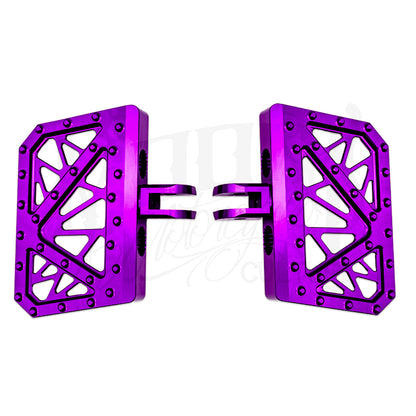 Pair of purple MOONSMC Softail M8 mini floorboards with geometric cutouts and traction pins.