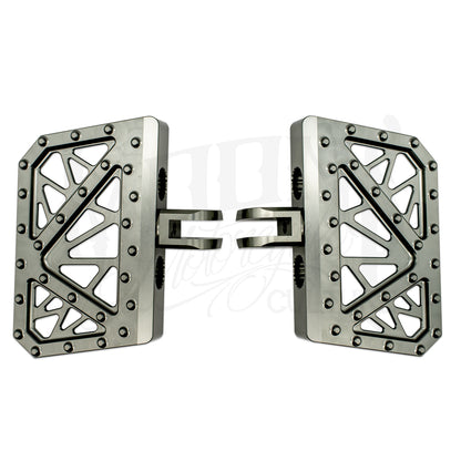 Pair of gray MOONSMC Softail M8 mini floorboards with geometric cutouts and traction pins.