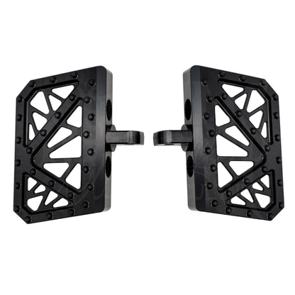 Pair of black MOONSMC mini floorboards for Dyna, FXR and Sportster, showing geometric cutouts and traction pins.