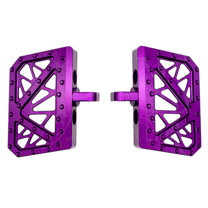 Pair of purple MOONSMC mini floorboards for Dyna, FXR and Sportster, showing geometric cutouts and traction pins.