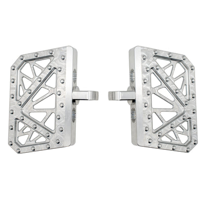 Pair of silver MOONSMC mini floorboards for Dyna, FXR and Sportster, showing geometric cutouts and traction pins.