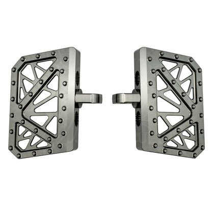 Pair of gray MOONSMC mini floorboards for Dyna, FXR and Sportster, showing geometric cutouts and traction pins.