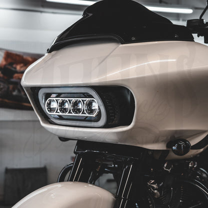 Front view of a white Road Glide fairing fitted with the MOONSMC Moonmaker 3 headlight.