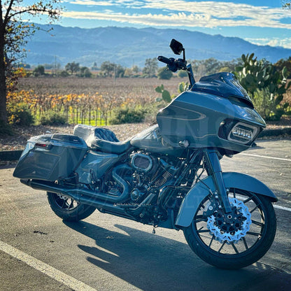 Road Glide motorcycle fitted with a MOONSMC Moonmaker 3 headlight parked beside a scenic mountain overlook.