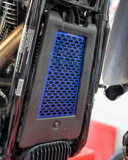 Blue MOONSMC honeycomb oil cooler guard installed at the front of a Softail M8.