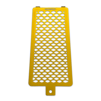 Front view of the gold MOONSMC Softail M8 oil cooler guard with a honeycomb pattern.