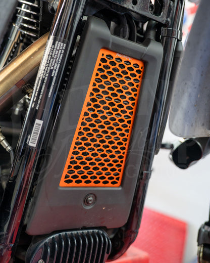 Orange MOONSMC honeycomb oil cooler guard installed at the front of a Softail M8.