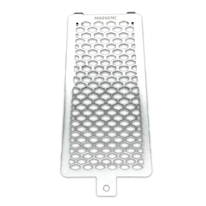 Front view of the silver MOONSMC Softail M8 oil cooler guard with a honeycomb pattern.