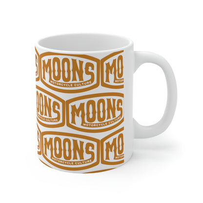 MOONSMC Vintage Badge Ceramic Mug 11oz: white mug with repeating gold badge logos, handle on the right.